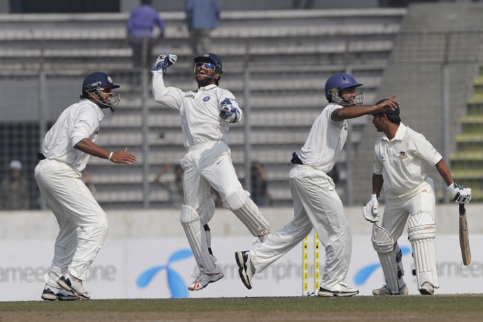 Mahendra Singh Dhoni and teammates Murali Vijay and Dinesh Karthik celebrate the dismissal of Mohammad Ashraful during the fourth day of the second Test match in Dhaka. (AFP Photo) India win Test series