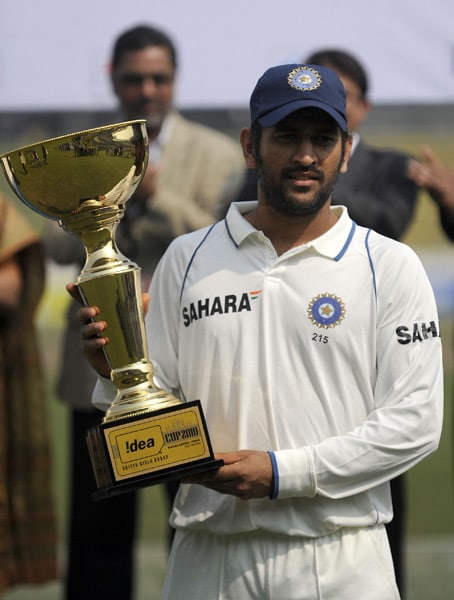Indian captain Mahendra Singh Dhoni holds the Test series trophy at the end of the second Test match between Bangladesh and India in Dhaka. (AFP Photo) India win Test series