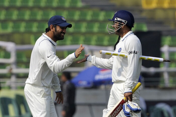 Mahendra Singh Dhoni and teammate Virender Sehwag celebrate victory during the fourth day of the second Test match in Dhaka. (AFP Photo) India win Test series