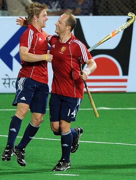 English hockey player Ashley Jackson (L) celebrates with teammate Ben Hawes after scoring a goal against India during their World Cup 2010 match at the Major Dhyan Chand Stadium in New Delhi. (AFP Photo) Unbeaten England enter semis