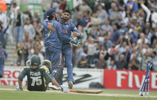 Younis Khan lies on the floor after being stumped by Mahendra Singh Dhoni, second left, as he celebrates with bowler Harbhajan Singh in their warm up match for the Twenty20 World Championship at the Oval in London. (AP Photo) Ind vs Pak warm-up match