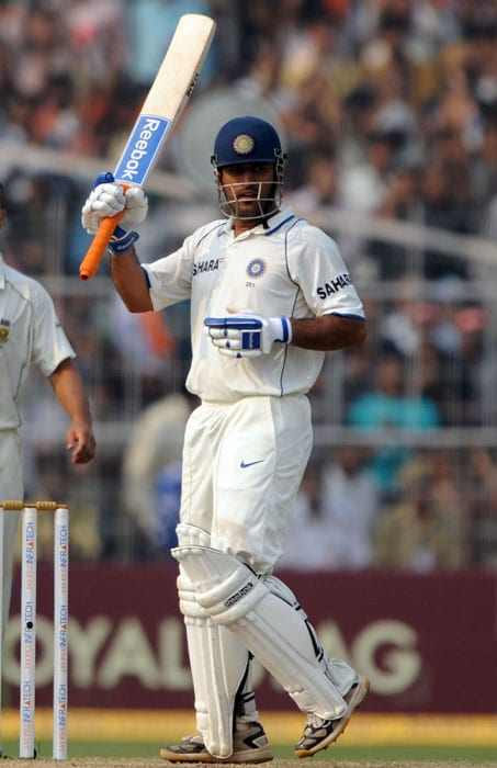 Mahendra Singh Dhoni raises his bat after scoring a century on the third day of the second Test match between India and South Africa at The Eden Gardens Cricket Stadium in Kolkata on February 16, 2010. India have scored 643 runs for the loss of six wickets after the South African score of 296 runs in their first innings. (AFP Photo) India vs SA: 2nd Test, Day 3