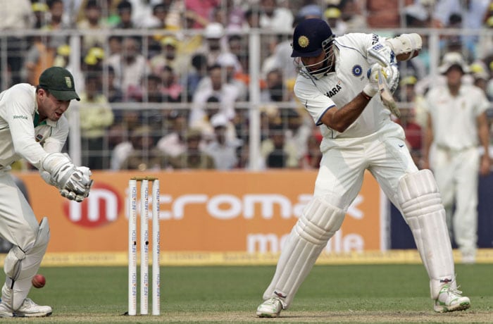 VVS Laxman bats as South Africa's AB de Villers tries unsuccessfully to catch the ball during the third day of the second Test match in Kolkata on Tuesday. (AP Photo) India vs SA: 2nd Test, Day 3