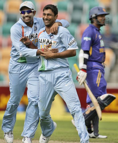 As Sri Lanka's KC Sangakkara right, walks off the field, Praveen Kumar, center, and teammate RV Uthappa celebrate during their tri-Series One-Day International Match in Hobart on Tuesday on February 26, 2008. 11th match - India vs Sri Lanka
