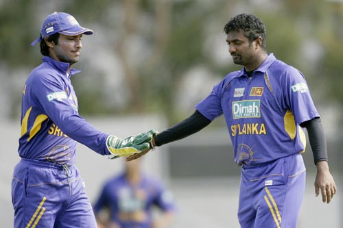 M Muralitharan, right, is congratulated by wicket keeper KC Sangakkara after taking the wicket of Tendulkar during their tri-series One-Day International match against India in Hobart on Tuesday, February 26, 2008. India are chasing 180 runs for victory. 11th match - India vs Sri Lanka