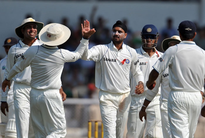 VVS Laxman congratulates teammate Harbhajan Singh for the wicket of Tharanga Paranavitana on the first day of the third Test between India and Sri Lanka in Mumbai. (AFP Photo) India vs SL: 3rd Test, Day 1