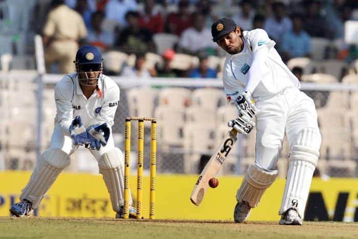 Mahendra Singh Dhoni watches as Tillakaratne Dilshanon bats on the first day of the third Test between India and Sri Lanka in Mumbai. (AFP Photo) India vs SL: 3rd Test, Day 1