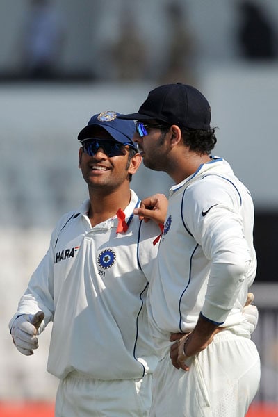 Mahendra Singh Dhoni and teammate Yuvraj Singh share a light moment during the drinks break on the first day of the third Test between India and Sri Lanka in Mumbai. (AFP Photo) India vs SL: 3rd Test, Day 1