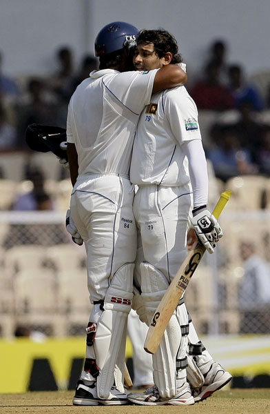 Kumar Sangakkara congratulates teammate Tillakaratne Dilshan for scoring a half-century on the first day of the third Test between India and Sri Lanka in Mumbai. (AP Photo) India vs SL: 3rd Test, Day 1