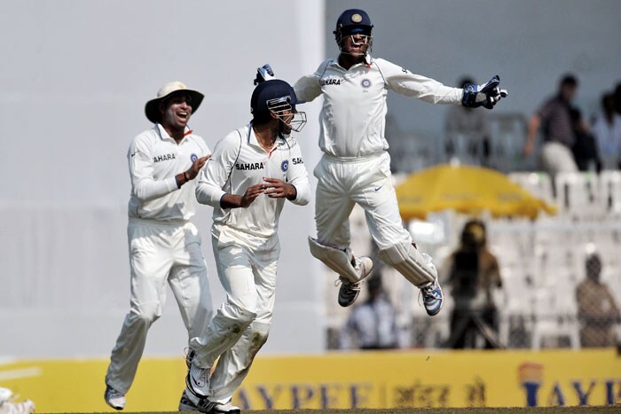 Mahendra Singh Dhoni celebrates the wicket of Kumara Sangakara with teammates on the first day of the third Test between India and Sri Lanka in Mumbai. (AFP Photo) India vs SL: 3rd Test, Day 1
