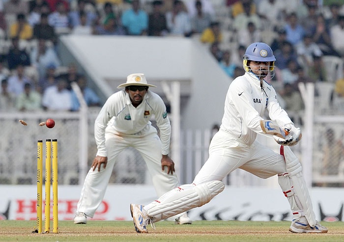 India's Harbhajan Singh is bowled by a delivery from Sri Lanka's Muttiah Muralitharan during the third day of the third Test in Mumbai on Friday. (AFP Photo) India vs SL: 3rd Test, Day 3