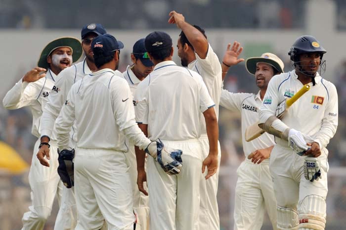 Indian cricketers celebrate the wicket of Sri Lanka's Kumara Sangakara on the final day of the third Test in Mumbai on Sunday. (AFP Photo) Men in Blue on top of the world