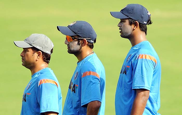 India's Sachin Tendulkar, Gautam Gambhir and Pragyan Ojha wait for their turn during a training session on the eve of the first Test against Sri Lanka in Ahmedabad Sunday. (AFP Photo) India, Lanka gear up for Tests
