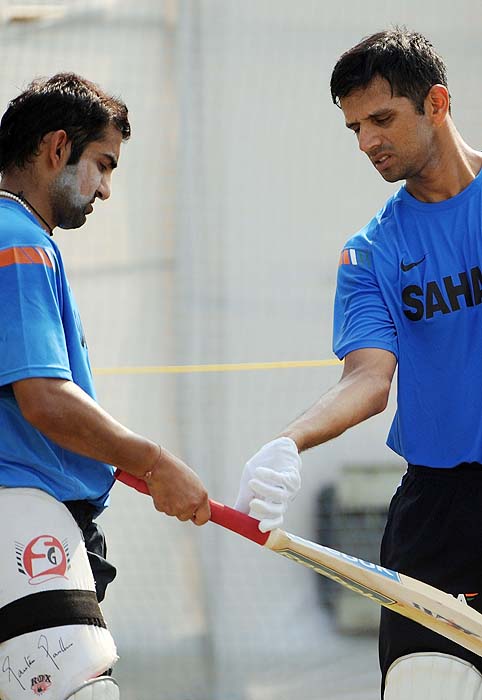 India's Gautam Gambhir gets batting tips from teammate Rahul Dravid during a training session on the eve of the first Test against Sri Lanka in Ahmedabad on Sunday. India's captain Mahendra Singh Dhoni urged Sachin Tendulkar to mark his third decade in world cricket with a century in the first Test against Sri Lanka. (AFP Photo) India, Lanka gear up for Tests