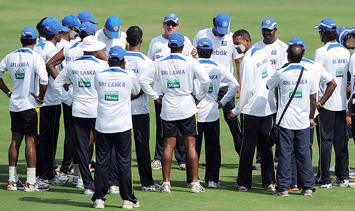 Sri Lankan cricketers form a huddle around coach Trevor Bayliss during a training session on the eve of the first Test against India in Ahmedabad on Sunday. (AFP Photo) India, Lanka gear up for Tests