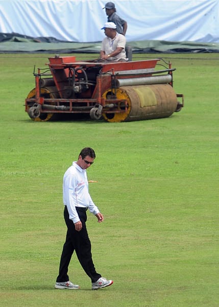 Australian umpire Rodney Tucker inspects the pitch following rain that delayed the start of the second day of the first Test match between Sri Lanka and India in Galle. (AFP Photo) India vs SL: 1st Test, Day 2