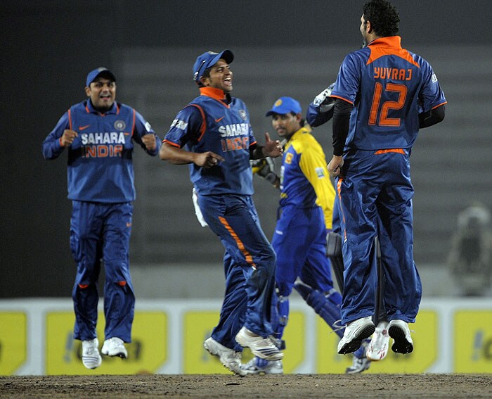 Suresh Raina, Yuvraj Singh and Virender Sehwag celebrate the dismissal of Tillakaratne Dilshan during the tri-series final between India and Sri Lanka at the Sher-e Bangla National Stadium in Dhaka. (AFP Photo) Tri-series Final: India vs SL
