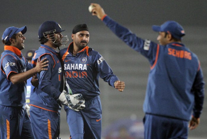 Harbhajan Singh celebrates with teammates the dismissal of Kumar Sangakkara during the tri-series final between India and Sri Lanka at the Sher-e Bangla National Stadium in Dhaka. (AP Photo) Tri-series Final: India vs SL