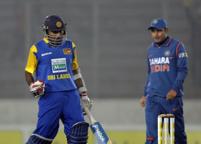 Mahela Jayawardene reacts after winning the match against India as Virender Sehwag looks on at the conclusion of the tri-series final between India and Sri Lanka at the Sher-e Bangla National Stadium in Dhaka. (AFP Photo) Tri-series Final: India vs SL