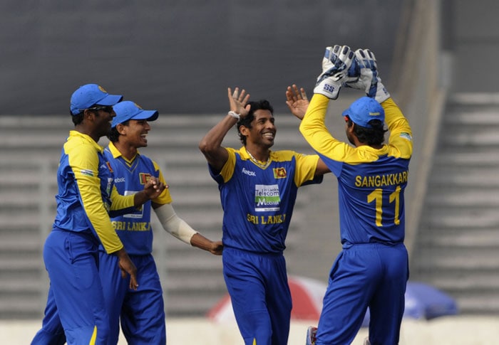 Chanaka Welegedara and captain Kumar Sangakkara celebrate the wicket of Yuvraj Singh during the tri-series final between India and Sri Lanka at the Sher-e Bangla National Stadium in Dhaka. (AFP Photo) Tri-series Final: India vs SL
