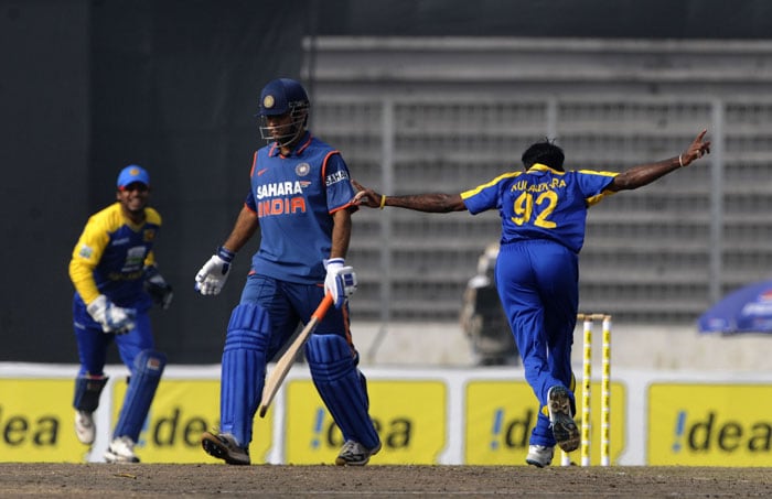 Nuwan Kulasekara and captain Kumar Sangakkara celebrate the dismissal of Mahendra Singh Dhoni during the tri-series final between India and Sri Lanka at the Sher-e Bangla National Stadium in Dhaka. (AFP Photo) Tri-series Final: India vs SL