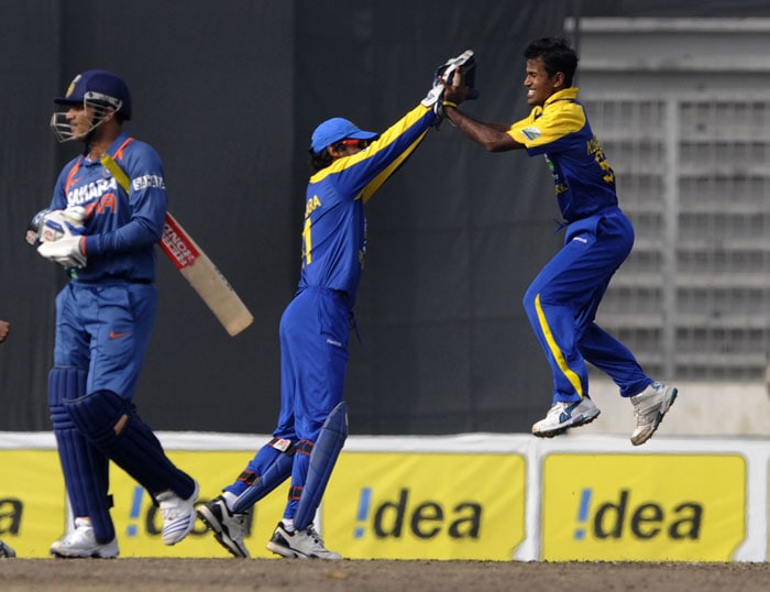 Nuwan Kulasekara and captain Kumar Sangakkara celebrate the dismissal of Virender Sehwag during the tri-series final between India and Sri Lanka at the Sher-e Bangla National Stadium in Dhaka. (AFP Photo) Tri-series Final: India vs SL