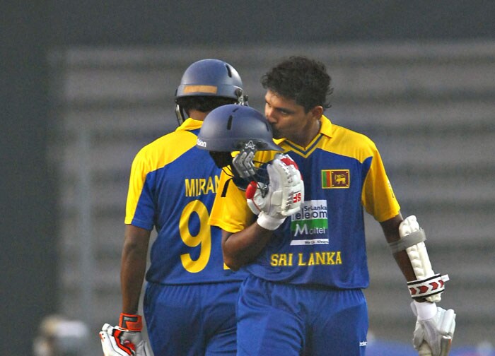Suraj Randiv kisses his helmet after scoring a half-century during the fifth ODI of the tri-nation tournament in Dhaka. (AFP Photo) 5th ODI: India vs SL