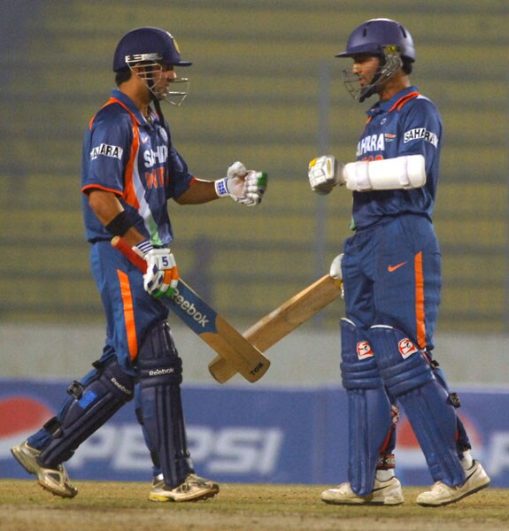 Gautam Gambhir and Dinesh Karthik celebrate after hitting a four during the fifth ODI of the tri-series in Dhaka. (AFP Photo) 5th ODI: India vs SL