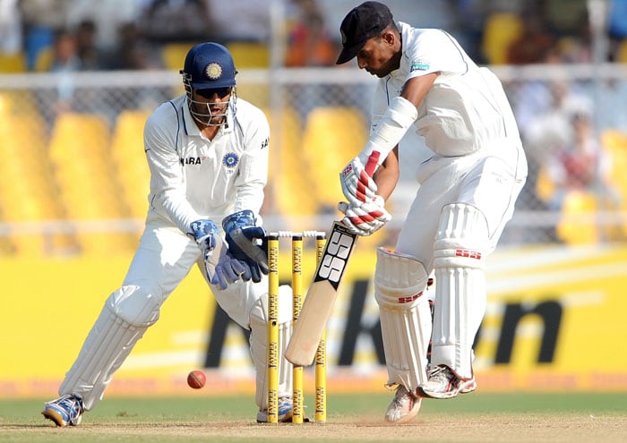 Mahendra Singh Dhoni looks on as Thilan Samaraweera batson the third day of the first Test between India and Sri Lanka at the Motera stadium in Ahmedabad. (AFP Photo) India vs SL: 1st Test, Day 3