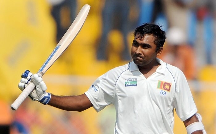 Mahela Jayawardene raises his bat to celebrate after scoring a century on the third day of the first Test between India and Sri Lanka at the Motera stadium in Ahmedabad. (AFP Photo) India vs SL: 1st Test, Day 3