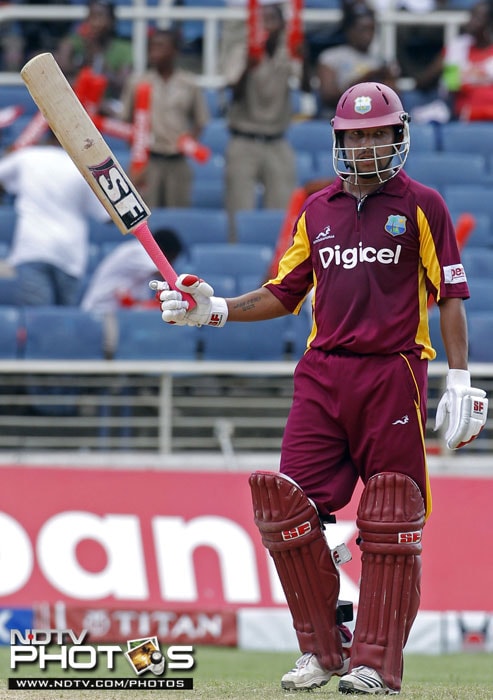 West Indies' Ramnaresh Sarwan raises his bat after scoring 50 runs during the fifth One-Day International against India in Kingston, Jamaica. (AP Photo) 5th ODI: India vs West Indies