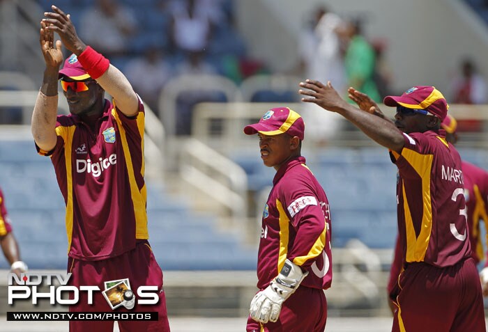 West Indies' captain Darren Sammy, wicketkeeper Carlton Baugh and Anthony Martin celebrate after India's batsman Virat Kohli was run out for 94 runs during their fifth One-Day International in Kingston, Jamaica. (AP Photo) 5th ODI: India vs West Indies