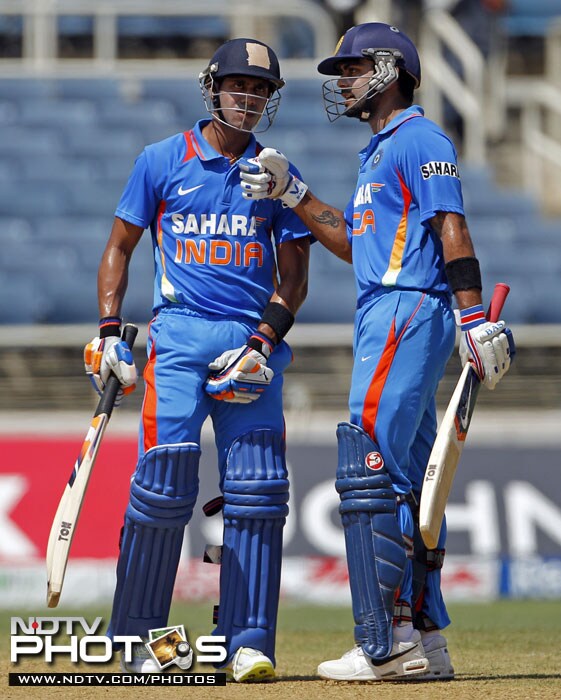 India's Virat Kohli congratulates his batting partner Manoj Tiwary after he played a shot for six runs off West Indies' captain Darren Sammy during their fifth One-Day International in Kingston, Jamaica. (AP Photo) 5th ODI: India vs West Indies
