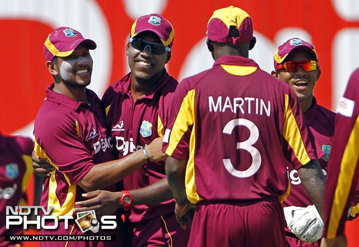 West Indies' Ramnaresh Sarwan is congratulated by teammates after taking the catch to dismiss India's Shikhar Dhawan for 11 runs during their fifth One-Day International in Kingston, Jamaica. (AP Photo) 5th ODI: India vs West Indies