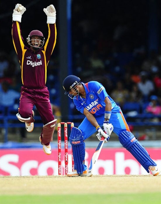 Carlton Baugh celebrates after catching behind Subramaniam Badrinath during the first ODI between West Indies and India at the Queen's Park Oval in Port of Spain. (AFP Photo) 1st ODI: India vs West Indies