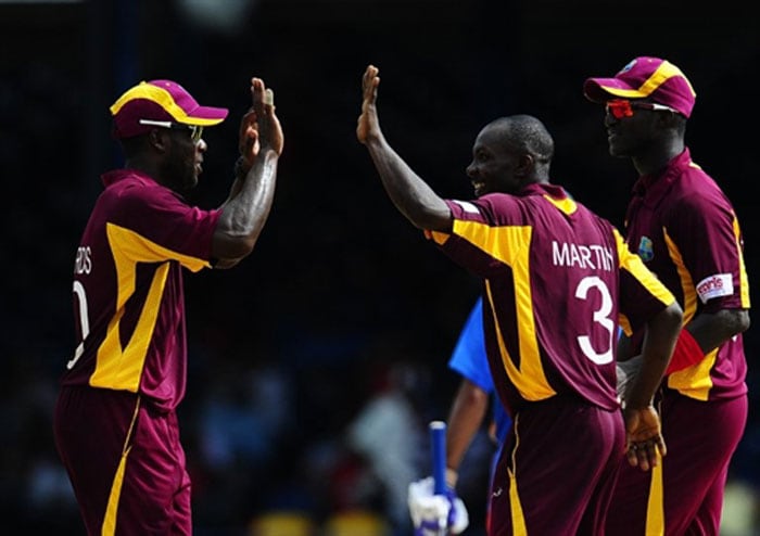 Anthony Martin celebrates with captain Darren Sammy and Kirk Edwards after taking the wicket of Shikhar Dhawan during the first ODI between West Indies and India at the Queen's Park Oval in Port of Spain. (AFP Photo) 1st ODI: India vs West Indies