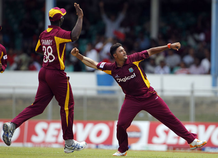 Ravi Rampaul celebrates with captain Darren Sammy after taking the wicket of Virat Kohli, who was caught behind for 2 runs, during their first One-Day International in Port of Spain, Trinidad. (AP Photo) 1st ODI: India vs West Indies