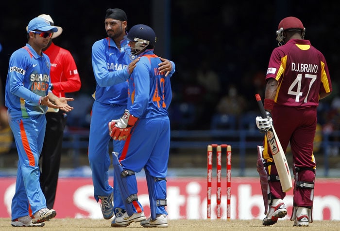 Parthiv Patel is congratulated by bowler Harbhajan Singh and captain Suresh Raina after his stumped out Dwayne Bravo during their first One-Day International in Port of Spain, Trinidad. (AP Photo) 1st ODI: India vs West Indies