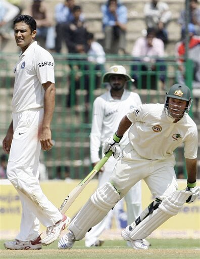 Ricky Ponting scores a run as Anil Kumble and Harbhajan Singh look on during the first day of the first Test between India and Australia in Bangalore. India vs Australia: 1st Test, Day 1