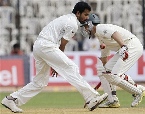 Zaheer Khan fields off his own bowling as Simon Katich takes evasive action on the first day of their first Test in Bangalore. India vs Australia: 1st Test, Day 1