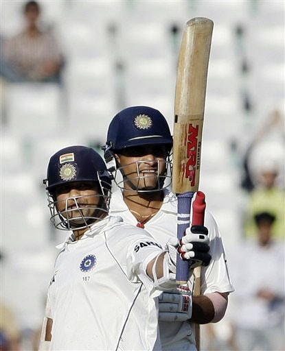 Sachin Tendulkar reacts after scoring fifty runs as teammate Sourav Ganguly looks on during the first day of the second Test between India and Australia in Mohali. India vs Australia: 2nd Test, Day 1