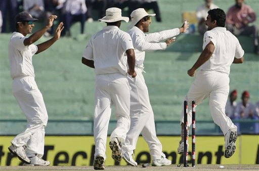 2. Rahul Dravid, Amit Mishra and VVS Laxman run-in to congratulate Zaheer Khan after he took the wicket of Brett Lee during the final day of the second Test between India and Australia in Mohali. India vs Australia: 2nd Test, Day 5