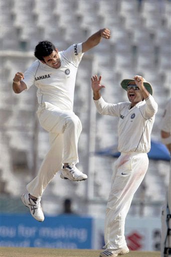 Zaheer Khan and Virender Sehwag celebrate after taking the wicket of Cameroon White on the final day of the second Test between India and Australia in Mohali. India vs Australia: 2nd Test, Day 5
