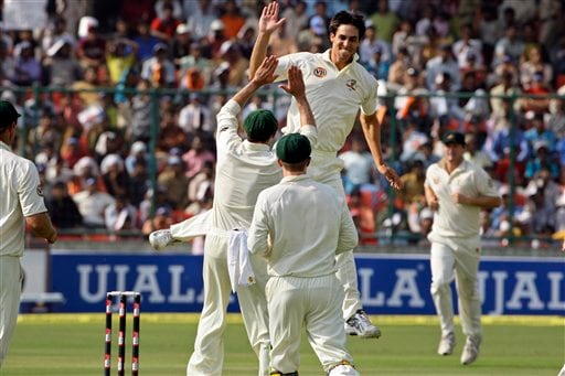 Mitchell Johnson celebrates with teammates after dismissing Sachin Tendulkar during the first day of their third cricket Test match in New Delhi on Wednesday, October, 2008. India vs Australia: 3rd Test, Day 1