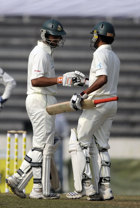 Mahmudullah Riyad shakes hand with his teammate Shafiul Islam after scoring a half century (50 runs) during the first day of the second Test at the Sher-e Bangla National Stadium in Dhaka. (AFP Photo) Ind vs B'desh: 2nd Test, Day 1