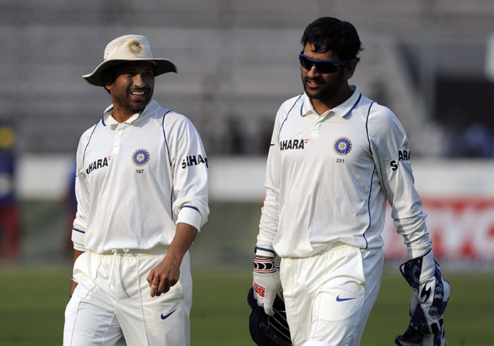 Indian cricket team captain Mahendra Singh Dhoni and his teammate Sachin Tendulkar leave the ground after the Bangladesh were skittled out for 233 runs in their first innings of the second test at The Sher-e Bangla National Stadium in Dhaka. (AFP Photo) Ind vs B'desh: 2nd Test, Day 1