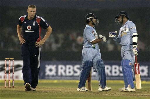 Virender Sehwag and Sachin Tendulkar greet each other after scoring a boundary as England bowler Andrew Flintoff looks on during the fifth One-Day International match between India and England in Cuttack. (AP Photo) India vs England: 5th ODI