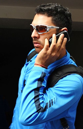 Yuvraj Singh speaks on a cellular telephone at The National Cricket Academy (NCA) at The M. Chinnaswamy Stadium in Bangalore. (AFP Photo) Team India fitness camp