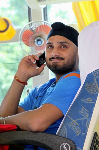 Harbhajan Singh talks on the phone in the team bus while leaving for the team's fitness and conditioning camp, ahead of tri-series in Sri Lanka and Champions Trophy, in Bangalore. (PTI Photo) Team India fitness camp