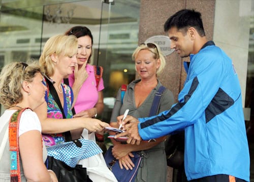 Rahul Dravid signs autograph for fans as he leaves for team's fitness and conditioning camp, ahead of tri-series in Sri Lanka and Champions Trophy, in Bangalore. (PTI Photo) Team India fitness camp